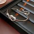 Detailed view of silver heart bracelet with interlocking zircon heart and lobster clasp - Silver