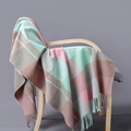 Plaid cashmere scarf in pink and mint green with tassels draped on a wooden chair - Pink Green Coffee Plaid