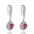 Macro detail of silver halo earrings with square red zircon stones and pavé diamonds - Red