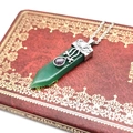 Macro detail of green crystal sword pendant with silver filigree on a red vintage box - Green Aventurine