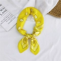 Yellow paisley silk square scarf tied on white linen background with books and basket - Classic Paisley Yellow / 70cm