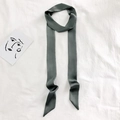 Minimalist dark grey narrow silk scarf for handbags or hair styling displayed on fabric - 200cm / Dark Gray