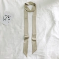 Elegant beige silk ribbon scarf for hair and handbags displayed on a linen background - 200cm / Champagne