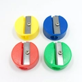 Mini round plastic pencil sharpeners in blue, yellow, red and green colors - Round
