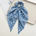 Detail of light blue floral fabric hair scrunchie with long ribbon on display tray - Blue (Style F)
