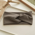 Detail of brown knitted headband with a knot design on a minimalist beige tray - Light Coffee