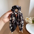 Detail of black satin hair scrunchie with floral ribbons and hanging white pearls - Black Ribbon