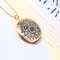 Close-up of golden round locket pendant with floral relief on vintage paper background - Round Embossed / Rose Gold
