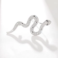 Elegant silver snake brooch set with sparkling cubic zirconia on a white textured background - Silver