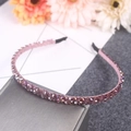 Chic headband featuring pink crystals and rhinestones for women on a grey display box - Double Row / Purple