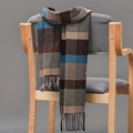 Detailed view of the plaid scarf texture and fringes draped on a wooden chair - Brown Blue Beige Plaid (02)