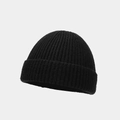 Detailed view of the black ribbed knit texture on a minimalist skullcap beanie - One Size / Black