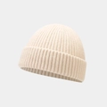 Detailed close-up of cream ribbed knit texture on a minimalist skullcap beanie - One Size / Beige