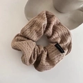 Macro detail of beige knitted scrunchie showing cable stitch texture and material label - Light Coffee