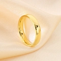 Macro shot of polished gold titanium wedding ring on elegant champagne silk background - US 6 / Men's Minimalist Plain Band Style (KR43436-K) / Gold