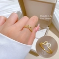Adjustable golden hollow ring featuring a minimalist design on a silk background - Gold Adjustable Open Style (G412)