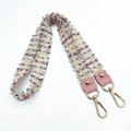 Detail of colorful woven shoulder strap with pink leather ends and gold metal hooks - Handheld/Underarm Style / Pink