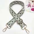 Close-up of bohemian geometric jacquard bag strap with polished gold metal swivel hooks - Gold Buckle / Green