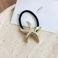 Detalle de una goma para el pelo con estrella de mar dorada para coletas de estilo elegante - Estrella de mar / Dorado