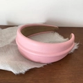 Close-up of pink leather headband with horizontal stitching on a rustic linen cloth - Pink