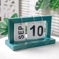 Minimalist teal wood flip calendar with white cards showing September 10 date - Blue