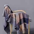 Detail of plaid cashmere blend scarf with tassels draped on a wooden chair - Navy Purple Beige Brown Plaid