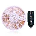 Macro detail of rose gold nail art charms in a pink organizer box with nail demonstration - Rose Gold Studs Disc