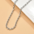 Close-up of silver-toned metal O-chain and links draped over a white ceramic piece - 10# 4.4mm Corner Chain (1m)