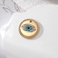 Vista macro detallada de un colgante de ojo turco dorado con diamantes de imitación - Ojo Redondo Dorado