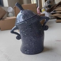 Attitude canister in dark grey with spots, featuring a quirky pose and dual handles - Gray