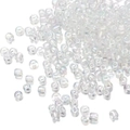 Macro shot of 2mm clear phantom glass seed beads scattered on a white surface - Iridescent Transparent 161