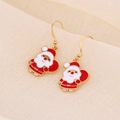 Detailed view of handmade Santa Claus earrings with red enamel and golden alloy hooks - Smiling Santa Claus