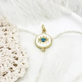 Macro detail of gold evil eye pendant with blue gemstone and micro-pave crystals - White Small Round Disc 19.7*12.6mm