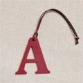 Detail of red leather letter A charm with textured finish and dark leather strap - Letter A Wine Red