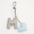 Detailed view of handmade leather M letter bag charm with blue heart and gray pebble texture - Light Blue Heart and Grey M