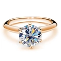 Close-up of six-prong rose gold ring featuring S925 hallmark and sparkling round gem - US 7 / White