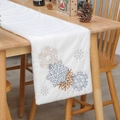 White faux fur Christmas table runner with embroidered snowflakes on a wooden dining table - Snowflake Embroidery
