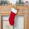 Calza di Natale in maglia rossa con bordo in pelliccia bianca sul caminetto - Rosso