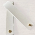 Two white PU leather luggage tags with gold snap buttons on light wood background - Folded Size 15x3cm / White
