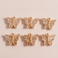 Vista macro di 6 ciondoli a farfalla in lega dorata con glitter argento per gioielli DIY - Giallo