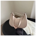 Detail of beige leather bag with small metal bow accent and wide shoulder strap - Khaki