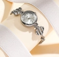 Silver luxury quartz watch with rhinestone encrusted镂空 strap on display stand - Four-leaf Clover Silver