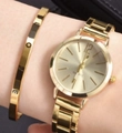 Close-up of gold quartz watch and engraved LOVE bracelet set on a wrist - Gold Steel LOVE Set