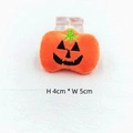 Detail of a 4x5cm plush Halloween pumpkin accessory with a smiling face and hair clip - Pumpkin With Brooch Pin
