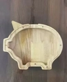 Detail of wooden pig money box showing smooth rubber wood grain and screw holes - Pig Left Ear
