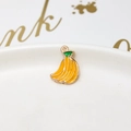 Macro shot of a handmade yellow enamel banana pendant with a gold alloy frame and top ring - 05# Bunch of Bananas
