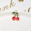 Detail shot of a red cherry alloy pendant with gold edges on white porcelain base - 18# Cherry