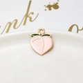Macro shot of pink peach alloy pendant with green leaf and golden metal border - 22# Peach