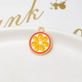 Detail of orange slice alloy pendant with gold plating on a white ceramic tray - 24# Orange Fruit