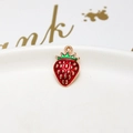 Macro shot of red strawberry pendant with gold seeds and green enamel details - 15# Dark Strawberry